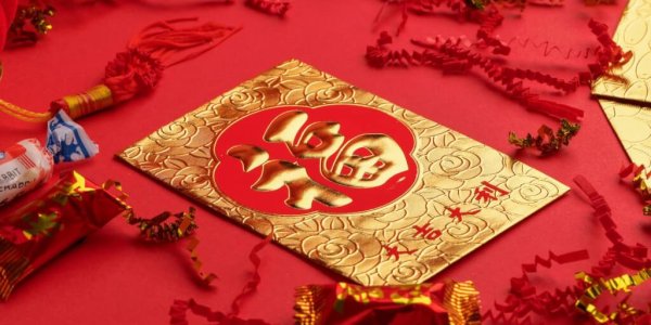 gold and white religious print book on red textile